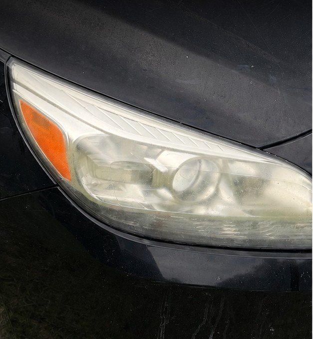 Same headlight before restoration, yellowed and cloudy